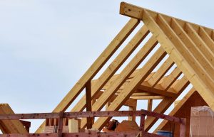 Wooden roof trusses installed on a house under construction.